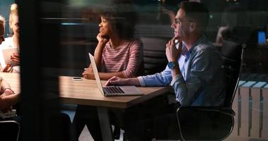 Multiethnic startup business team in night office photo