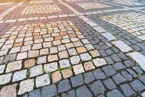Old paving stones pattern. Texture of ancient german cobblestone in city downtown. Little granite tiles. Antique gray pavements. photo