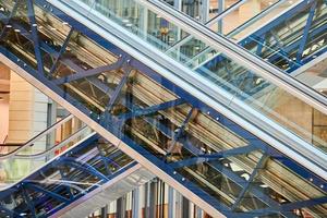 Crisscross escalators in shopping center photo