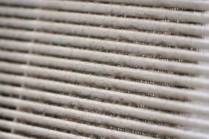 Dirty air ventilation grill of HVAC with clogged filter. photo