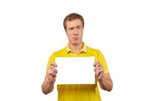 Suspicious guy holding blank paper sheet, paper mockup isolated on white background photo