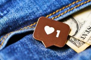 Like heart symbol and dollar in jeans pocket photo