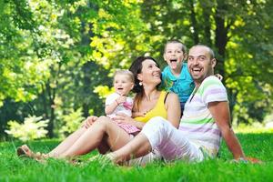 happy young couple with their children have fun at park photo