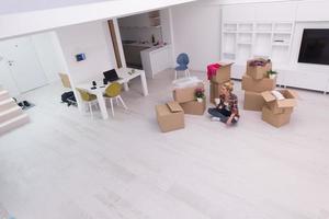 woman with many cardboard boxes sitting on floor photo