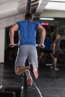 man doing exercises parallel bars photo