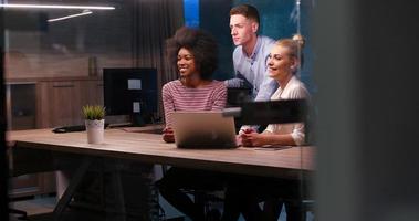 Multiethnic startup business team in night office photo