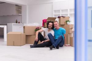 young  gay couple moving  in new house photo