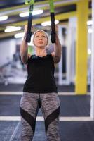 woman working out pull ups with gymnastic rings photo