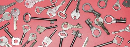 Keys set on pink background. Door lock keys and safes for proper photo