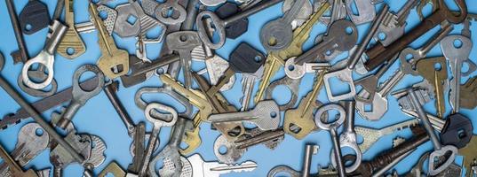 Keys set on blue background. Door lock keys and safes for property security and house protection. Different antique and new types of keys. photo