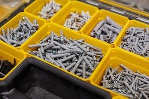 Storage case with screws, nuts, bolts, nails and other small tools for handyman, close up photo