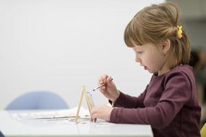 little girl painting on canvas photo