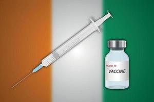 Syringe and vaccine vial on blur background with Ivory Coast fla vector