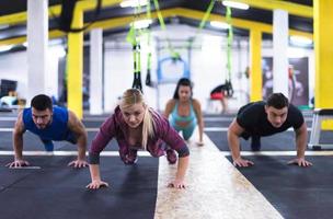 young healthy people doing pushups photo