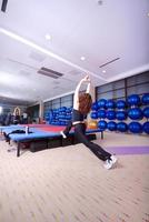 pretty girl warming up in fitness studio photo