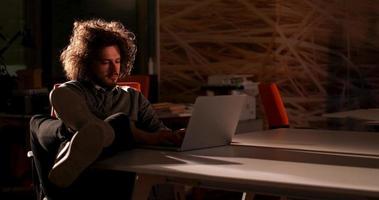 businessman sitting with legs on desk at office photo