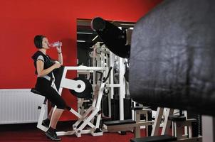 Young woman doing fitness in gym photo