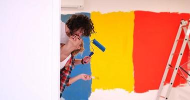 portrait of a couple painting interior wall photo
