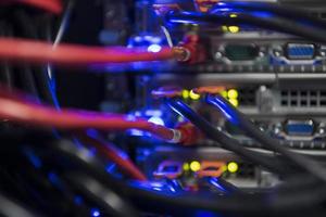 network server room closeup on fiber optic hub or switch for digital communications and internet in mainframe corporate business data center supercomputer. photo