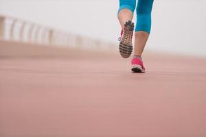 woman busy running on the promenade photo