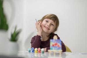 little girl painting on canvas photo