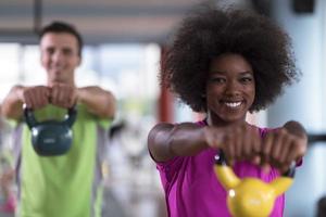 couple  workout with weights at  crossfit gym photo