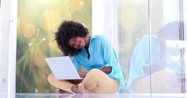 black women using laptop computer on the floor photo