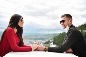 couple with protective medical mask  having coffee break in a restaurant photo