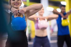 athletes doing exercises with kettlebells photo