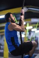 man doing rope climbing photo