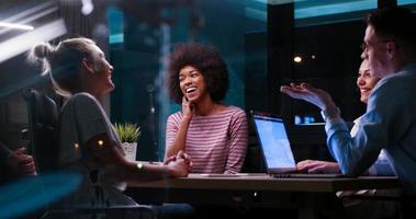Multiethnic startup business team in night office photo