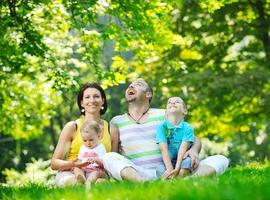 happy young couple with their children have fun at park photo