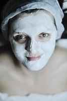 woman with facial mask in cosmetic studio photo