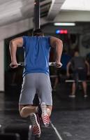 man doing exercises parallel bars photo