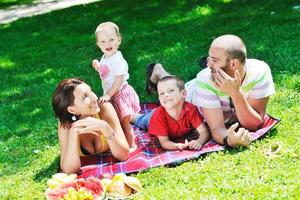 happy young couple with their children have fun at park photo