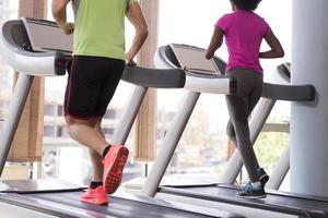 people exercisinng a cardio on treadmill in gym photo