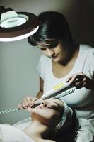 woman with facial mask in cosmetic studio photo