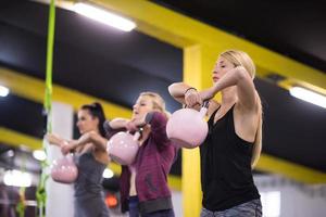 athletes doing exercises with kettlebells photo