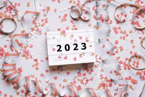 happy new year 2023 celebration flat lay with confetti and streamers photo