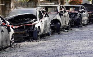 burnt out car wrecks in residential street after vandalism in Germany photo