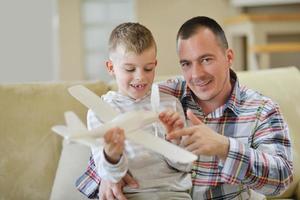 father and son assembling airplane toy photo