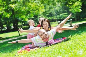 happy young couple with their children have fun at park photo