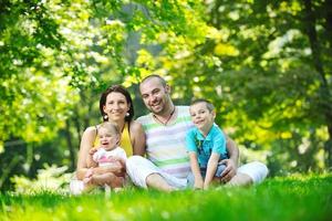 happy young couple with their children have fun at park photo