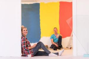 Happy young couple relaxing after painting photo