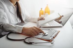 Medicine doctor and stethoscope touching icon medical network connection with modern interface on digital tablet in hospital background. Medical technology network concept photo