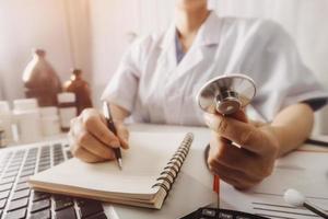 Medicine doctor and stethoscope touching icon medical network connection with modern interface on digital tablet in hospital background. Medical technology network concept photo