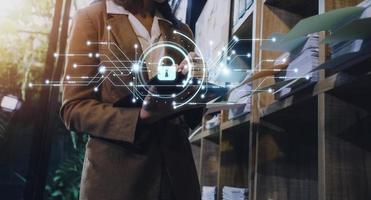 Cybersecurity and privacy concepts to protect data. Lock icon and internet network security technology. Businessman protecting personal data on smart phone with virtual screen interfaces. photo