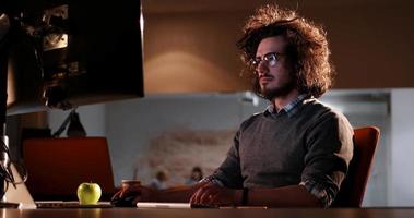 man working on computer in dark office photo