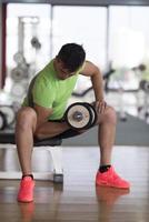 handsome man working out with dumbbells photo