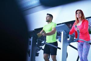 Group of people running on treadmills photo